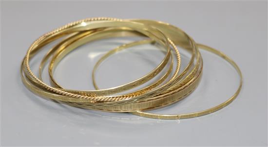 Seven assorted Austro-Hungarian 585 yellow metal bangles.